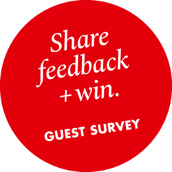 Red circle with text “Share feedback + win. Guest survey”