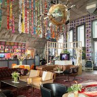 Artistically designed room with sofas, colourful origami cranes and creative furnishings.