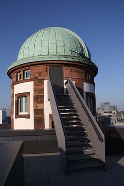 Historic observatory with green dome and rooftop access
