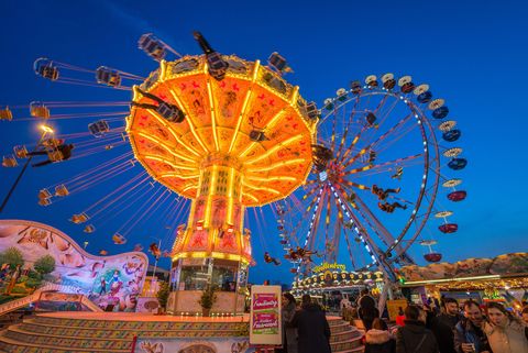 A chain carousel turns in the evening light. 