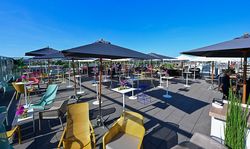 Spacious rooftop terrace with lounge furniture and sunshades