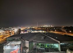 Night view of a city with illuminated skyline and modern buildings.