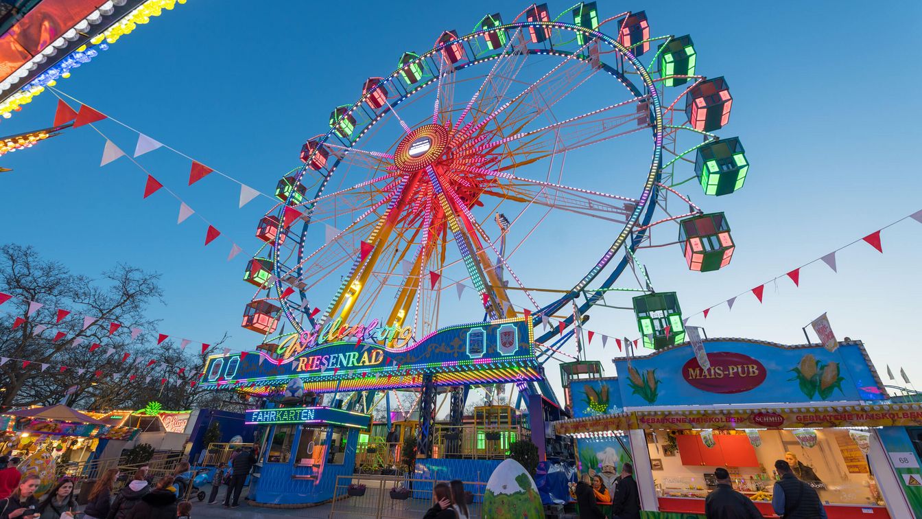 An illuminated Ferris wheel at a funfair.